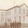 The Cauley Brothers and Father Discoll in front of the rectory.